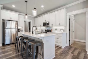 This modern kitchen is well stocked and equipped for your cooking needs.