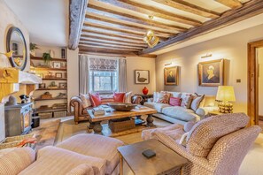 Art work and beautiful fabrics make for a cosy living room.