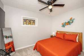 The first bedroom retreat features a plush queen bed & smart TV