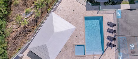 Pool with shaded gazebo and lounge chairs