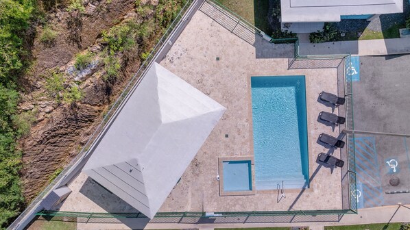 Pool with shaded gazebo and lounge chairs