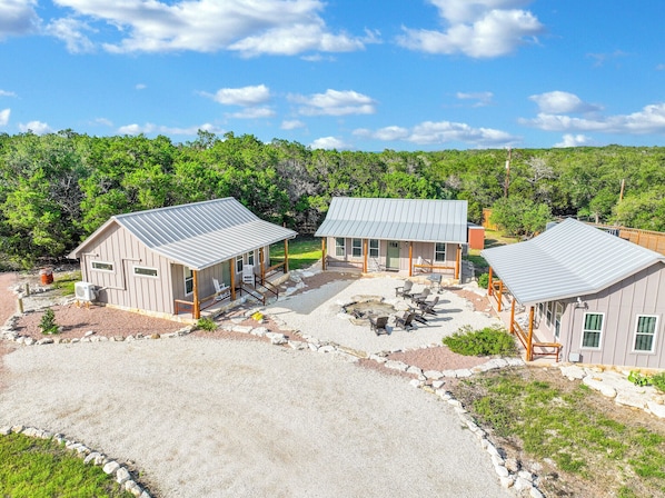Aerial view of cabins 4, 5, and 6 with the communal firepit.