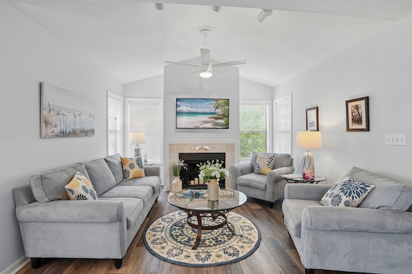 Fireplace Living Room at 308 Harbour Oaks - Soft gray sofas, a mounted TV, and a clean-lined fireplace set the scene for slow mornings or post-beach recovery. It’s the kind of space where you could almost forget how close you are to Mallery Street and that second drink at Murphy’s Tavern.