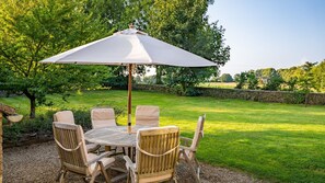 The garden is an oasis of lush greenery with an enclosed lawn perfect for games