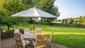 The garden is an oasis of lush greenery with an enclosed lawn perfect for games