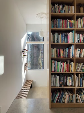 View of mudroom and built-in bookcase