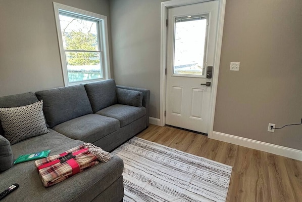 Enter into the living space with a pull out sleeper sofa and 50" TV