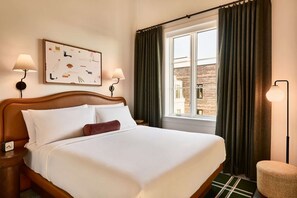 King bed with soft light and framed art above the headboard