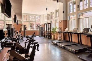 Fitness Room with cardio machines and strength area.