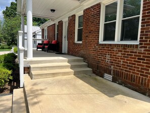 Steps leading up to the front door. Plent of covered and uncovered area on the front porch.
