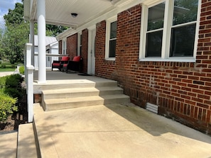 Steps leading up to the front door. Plent of covered and uncovered area on the front porch.