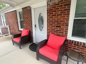 Two oversized chairs each with side table.