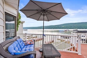 Relax on the cozy lakeside patio with stunning water views and a shaded spot to unwind. Perfect for a peaceful retreat!