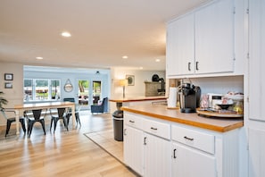 A bright and spacious kitchen with modern appliances, clean lines, and open shelving—perfect for preparing meals or enjoying your morning coffee. 🌟🍽️☕