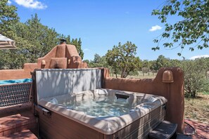 Unwind in the hot tub as the sun sets over the Santa Fe landscape.