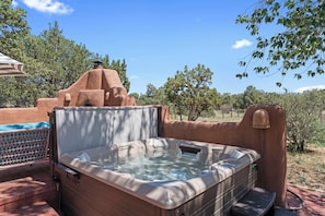 Unwind in the hot tub as the sun sets over the Santa Fe landscape.