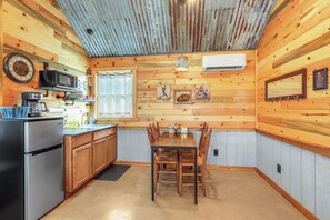 Kitchenette with microwave, refrigerator, and coffee pot.