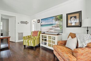 Living Room – Bright, Stylish, and Streaming-Ready - The living room at this St. Simons vacation rental brings the vibe. Natural light, a smart TV with streaming, and just the right mix of color and comfort make this your home base between beach walks and Village nights. The layout flows easily into the dining area and kitchen, perfect for lazy mornings or end-of-day recharging.