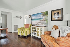 Living Room – Bright, Stylish, and Streaming-Ready - The living room at this St. Simons vacation rental brings the vibe. Natural light, a smart TV with streaming, and just the right mix of color and comfort make this your home base between beach walks and Village nights. The layout flows easily into the dining area and kitchen, perfect for lazy mornings or end-of-day recharging.