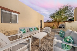 HOUSE: Private, fully fenced backyard with cozy seating and gas grill