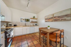 HOUSE: Updated, well-equipped kitchen with dining table that seats four
