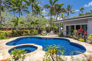 Lush landscaping surrounds the crystal-clear pool for total tropical privacy.