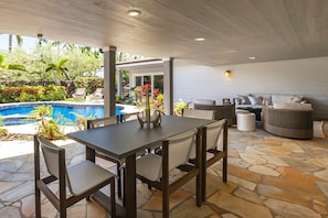 Have meals outside in the fresh air on this covered lanai by the pool.
