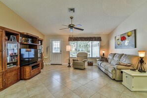Spacious Living Room with cathedral ceilings, tile floors, recliner, couch