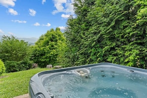 Sink into the bubbling hot tub and let the mountain air melt your stress away—your private spa moment awaits.