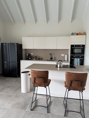 Full kitchen with large fridge and all appliances.
