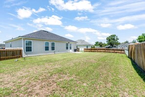 Relax and let loose in the private, fenced in back yard with a BBQ grill!