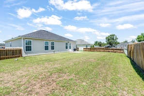 Relax and let loose in the private, fenced in back yard with a BBQ grill!