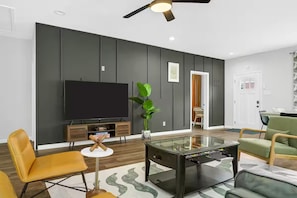 Living Room with TV Console and a coffee table with foosball table