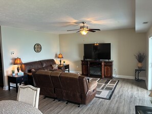Dual recliners , 3 seat sofa with 75" smart tv, fireplace and lake view