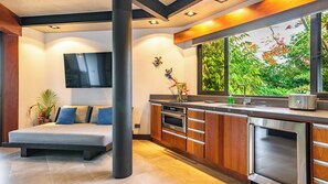 Kitchen with convection/microwave oven, mini fridge, ice maker, cooktop, and more