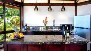 Full kitchen with cooktop, microwave, and refrigerator/freezer