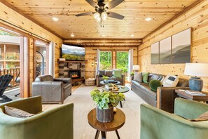 Main living area with plenty of seating, fireplace, and large TV.