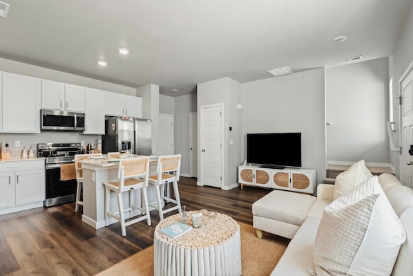 Spacious living area with dining and fully stocked kitchen