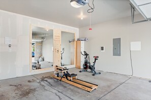 2 car garage with stationary bike and rower