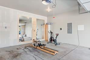 2 car garage with stationary bike and rower