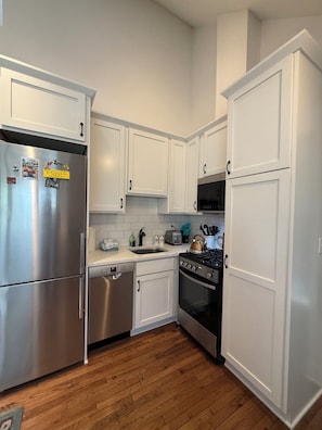 Kitchen with stainless appliances. Appliances are smaller than standard size