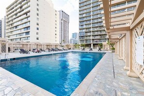 Stylish pool deck surrounded by city views