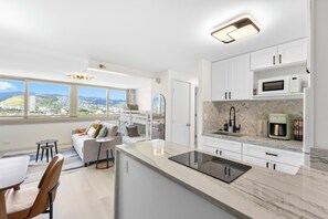 Open-concept living with mountain and city views