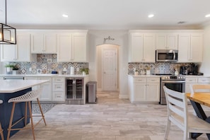 Kitchen: Main floor, drip coffee maker, Keurig, air fryer, Crockpot, toaster oven, blender, cooking utensils, tableware