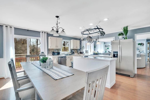 A spacious open floor plan seamlessly connects the kitchen and dining area—perfect for cooking, entertaining, and gathering.