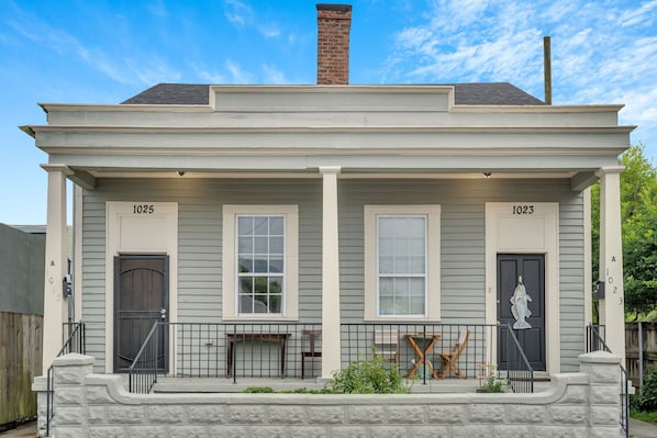 Charming New Orleans double with classic front porch seating.