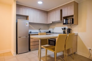 Cozy modern kitchen with sleek appliances and a convenient breakfast bar for a delightful start to your day.