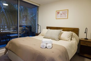 Relax in this cozy bedroom with a private patio view, perfect for unwinding after a day of adventure.