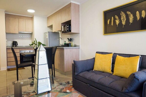 Charming studio with cozy seating, vibrant decor, and a fully-equipped kitchenette—perfect for a relaxing stay in the heart of Chile.