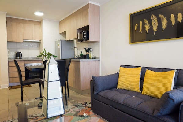 Charming studio with cozy seating, vibrant decor, and a fully-equipped kitchenette—perfect for a relaxing stay in the heart of Chile.